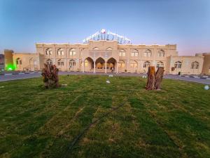 a large building with trees in front of it at Ibri Oasis Hotel in Ibri