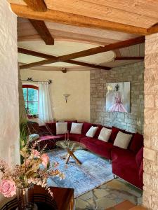 a living room with a red couch and a table at Altmuehl Familienvilla in Treuchtlingen