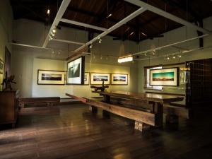 a room with benches and pictures on the walls at Jiwa Jawa Resort Bromo in Bromo