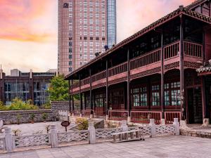 a large building in a city with tall buildings at Novotel Guiyang Downtown in Guiyang