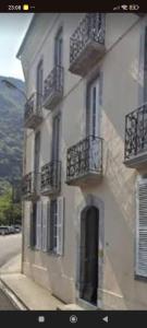 a building with balconies on the side of a street at Appartement T3 2 chambres - 6 personnes in Luz-Saint-Sauveur