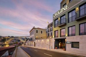 a building with a bridge in the background at Origine Porto Gaia, a Tribute Portfolio Hotel in Vila Nova de Gaia