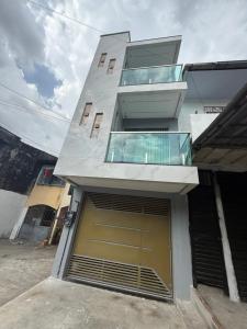 a large building with a garage with a door at Triplex Belém in Belém