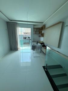 a room with a white floor and a chalkboard on the wall at Triplex Belém in Belém
