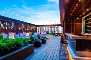 a patio with chairs and tables on a building at Aloft Taipei Beitou in Taipei