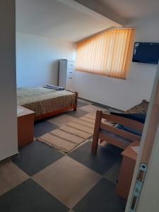 a room with two beds and a bench in it at Vila Kostadinovic in Pirot +8 photos