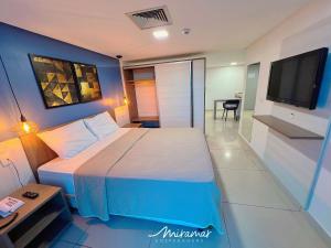 TambaúにあるImperial Nobileの大きなベッドとテレビのある寝室