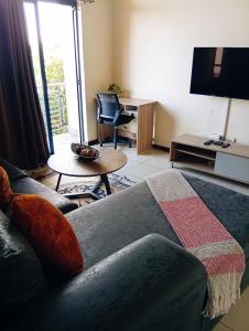 a living room with a couch and a table at The Jackal's Retreat in Roodepoort +24 photos