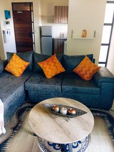 a living room with a couch and a table at The Jackal's Retreat in Roodepoort
