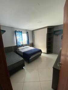 Ένα ή περισσότερα κρεβάτια σε δωμάτιο στο Casa para temporada em Rio das Ostras