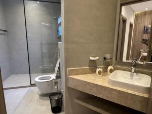 a bathroom with a sink and a toilet and a shower at Mozaik Condotel in Cairo