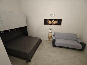 a bedroom with a bed and a chair in it at B&B Delle Rose in Orta Nova