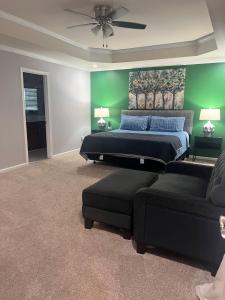 a bedroom with a bed and a couch at Midlong Term Rental Comforts Of Home Ft Eustis in Stoney Brook Estates
