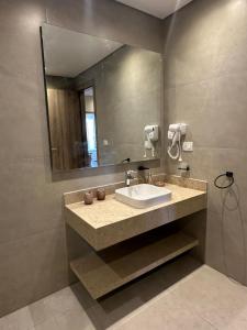 a bathroom with a sink and a mirror at Mozaik Condotel in Cairo