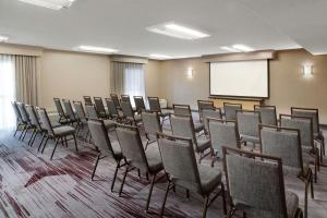 a conference room with chairs and a white screen at Courtyard Dallas Las Colinas in Irving +34 photos