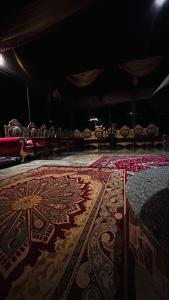 a room with a carpet with a cross on it at Fire bedouin camp in Wadi Rum