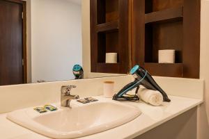 a bathroom sink with a mask on top of it at Flats Hotel Paulista | Delfhy in São Paulo +80 photos