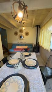 a dining room with a table with plates on it at Cabaña "House" in El Chalten