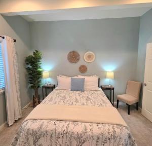 a bedroom with a large bed and two chairs at Immaculate Home w/ Mtn and River Views! in East Wenatchee