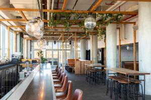 a large room with tables and chairs and windows at Hotel Indigo Lower East Side New York by IHG in New York