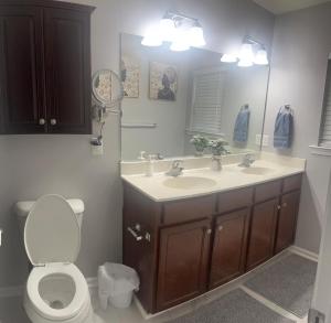 a bathroom with a sink and a toilet and a mirror at Midlong Term Rental Comforts Of Home Ft Eustis in Stoney Brook Estates +17 photos