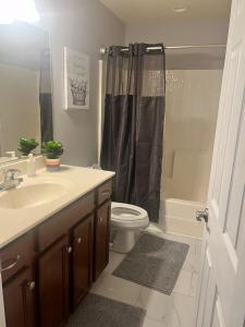 a bathroom with a sink and a toilet and a shower at Midlong Term Rental Comforts Of Home Ft Eustis in Stoney Brook Estates
