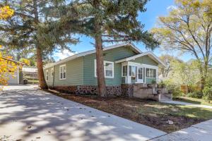 a green house with a tree in front of it at Route 66 Retreat Dog-Friendly Home in Williams in Williams