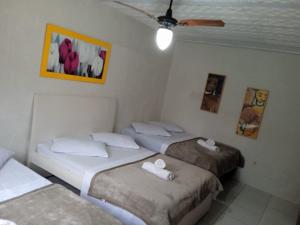 two beds in a hotel room with towels on them at Casa Soul Green in Paraty +35 photos