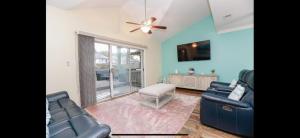 a living room with two couches and a ceiling fan at MidLongTerm Rntal Comfy Home Away Near VA Beach in Virginia Beach