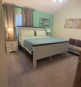 a bedroom with a large bed and a couch at MidLongTerm Rntal Comfy Home Away Near VA Beach in Virginia Beach