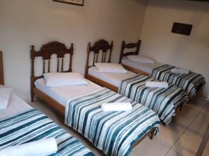 En eller flere senge i et værelse på Light House Pousada