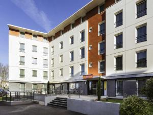 a white building with a staircase in front of it at Aparthotel Adagio Access Orléans in Orléans