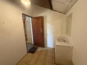 an empty room with a sink and a door at Pai Yard Guest House in Pai