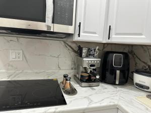 a kitchen counter with a coffee maker and a coffeemaker at peace in Fort Myers