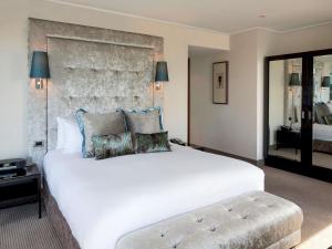a bedroom with a large white bed with pillows at Sofitel Auckland Viaduct Harbour in Auckland +80 photos