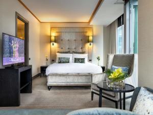 a hotel room with a bed and a television at Sofitel Auckland Viaduct Harbour in Auckland +112 photos