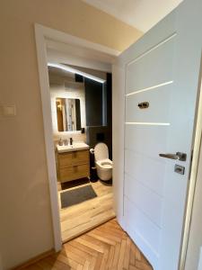 a bathroom with a toilet and a sink at Okrzei 15 - poczuj się jak w domu in Sopot +28 photos