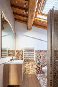 a bathroom with a sink and a toilet and a window at Small Villa with parking in Florence