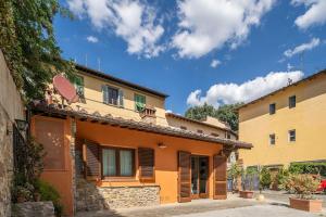 an orange house with a balcony on top of it at Small Villa with parking in Florence