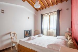 a bedroom with a large white bed and a window at Small Villa with parking in Florence