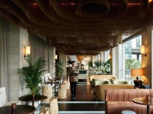 a man is walking through a hotel lobby at Pullman Quay Grand Sydney Harbour in Sydney
