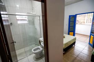 a bathroom with a toilet and a bed in a room at Villa Jardineira in Ouro Preto +13 photos