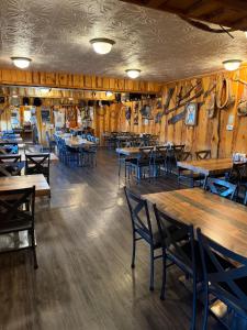 a dining room with wooden tables and chairs at Frontier Lodge in Lander