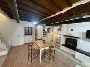 a kitchen with a wooden table and chairs at Borgo Vico in Fiordimonte
