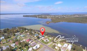 an aerial view of a lake with a red marker at Jerrinja - Absolute waterfront with jetty - 5 mins to Hyams Beach in Erowal Bay