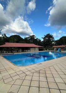 a large swimming pool with a building in the background at Wonderful lakefront house in a luxury condominium - Ananindeua in Ananindeua
