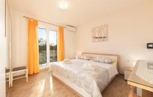 a bedroom with a bed and a large window at Amazing Home In Makarska in Veliko Brdo