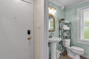 a bathroom with a white toilet and a sink at Success Loft in Lakeland +33 photos