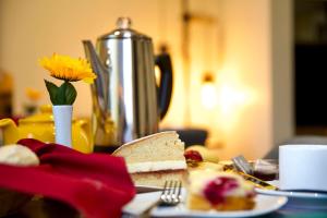 a table with a plate of food and a sandwich at Tu Guesthouse in Stanley