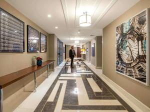 a man walking down a hallway in a building at The Artisan Hotel Istanbul - MGallery Collection in Istanbul